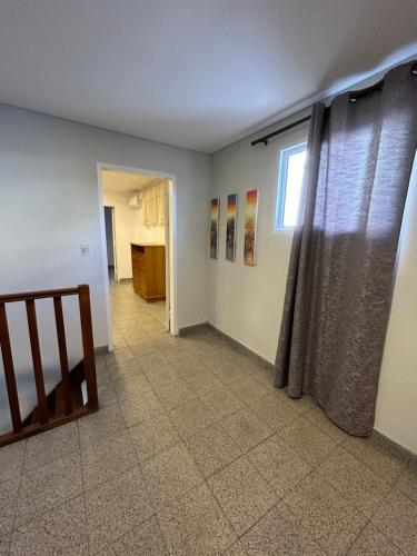 a living room with a staircase and a window at Departamento Completo, 3 habitaciones. Excelente ubicación in Asuncion