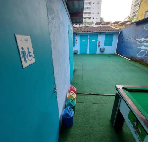 a room with a ping pong table and a pool table at Rolds Hostel in Santos