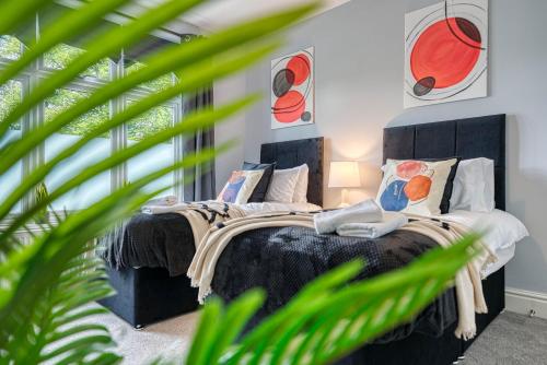 a bedroom with a large bed with pillows at Spacious House in Nottingham - Sleeps 16 in Nottingham