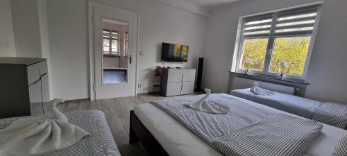 a bedroom with two beds with swans on them at Vila Věrka in Krásná Lípa