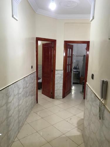 a hallway with two doors and a tile floor at ESC Apartments in Fès