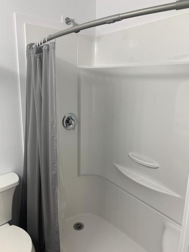 a bathroom with a shower with a shower curtain at Nor Villa Hotel in Winnipeg