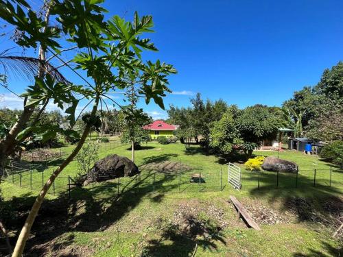 a park with a fence and some rocks and trees at FARE ARIKI MOOREA in Afareaitu