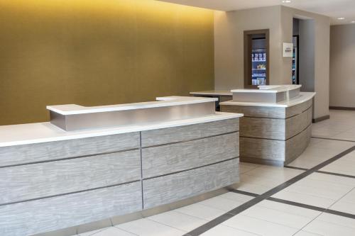 a lobby of a hotel with two counters at Residence Inn by Marriott Kansas City at The Legends in Kansas City