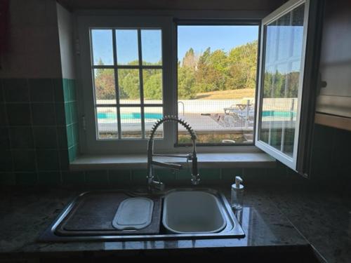 um lavatório numa cozinha com uma janela e um lavatório em Casa Jasmim em Azeitao