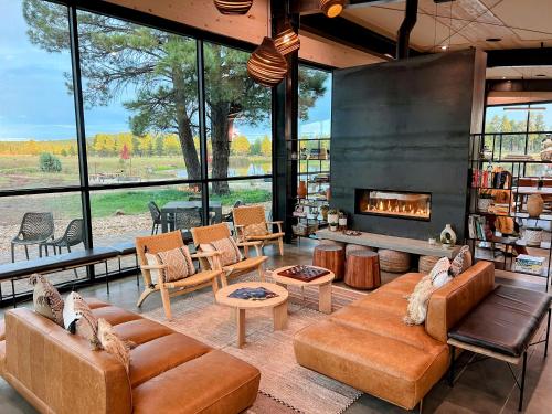 a living room with a couch and a fireplace at Backland in Williams