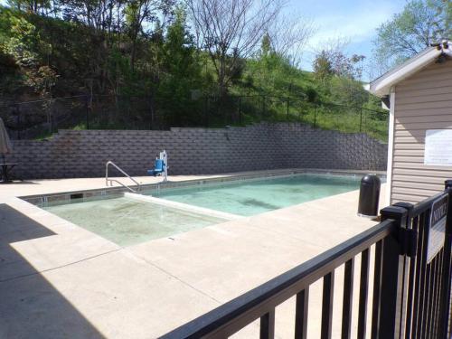 a swimming pool in a backyard with a fence at The Vista in Branson