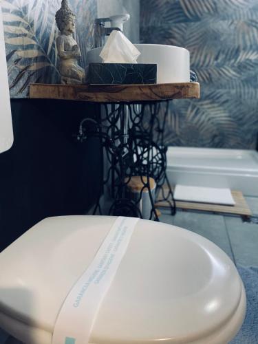 a white toilet sitting in a bathroom next to a sink at Rooms & Apartment ZALA in Cerklje na Gorenjskem