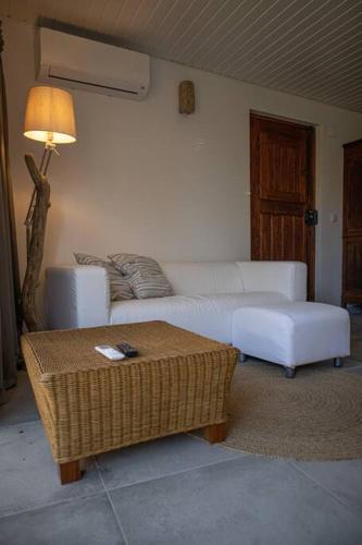 a living room with a white couch and a table at Pé na Praia in Torres Vedras