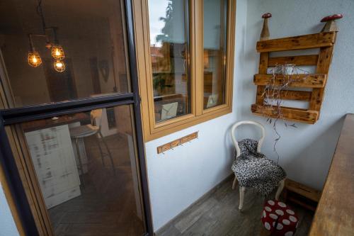 a room with a table and a chair next to a window at Tri pera -- self check in in Osijek