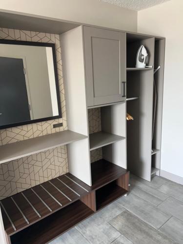 a living room with a tv and some shelves at Holiday Inn Chicago Midway Airport S by IHG in Chicago