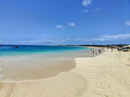 a group of people walking on the beach at Albis Harena - Meridiana Private Apartment Ocean View in Santa Maria