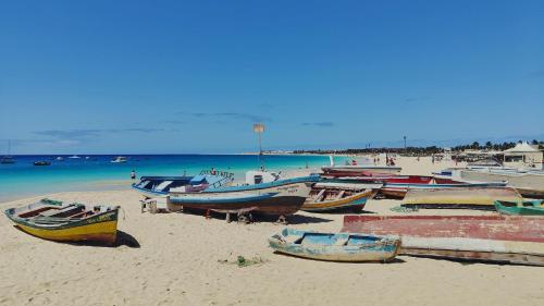 a group of boats sitting on a sandy beach at Albis Harena - Meridiana Private Apartment Ocean View in Santa Maria