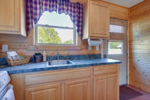 a kitchen with a sink and a window at Lakefront Vacation Rental with Patio and Grill! in Columbia