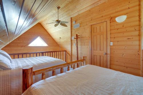 a bedroom with two beds in a log cabin at Lakefront Vacation Rental with Patio and Grill! in Columbia