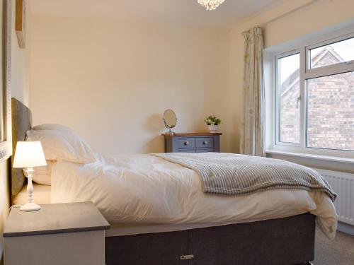 a bedroom with a large bed and a window at Lily J Rose in Braunston