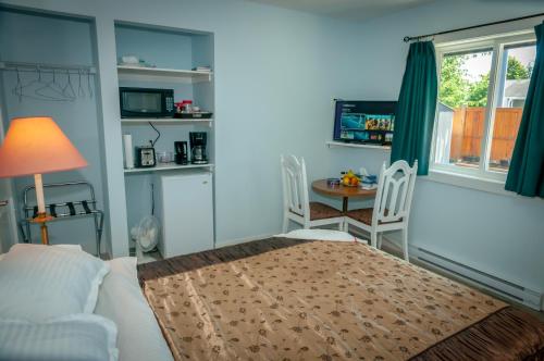 a living room with a bed and a table and chairs at Guest Suite Private Retreat for 2 Guests With AC - 4 Units Available in Abbotsford