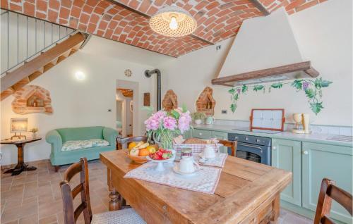 a kitchen with a wooden table in a room at Gorgeous Home In Ferrere With Kitchen in Ferrere
