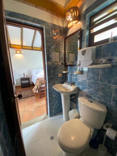a bathroom with a toilet and a sink at Cabañas Sol y Luna in Villa de Leyva