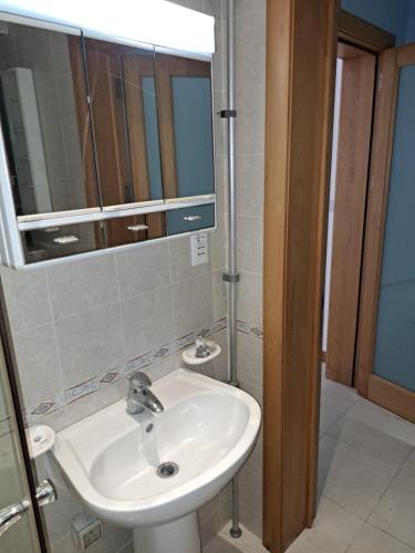 a bathroom with a sink and a mirror at Holiopolis in St Paul's Bay