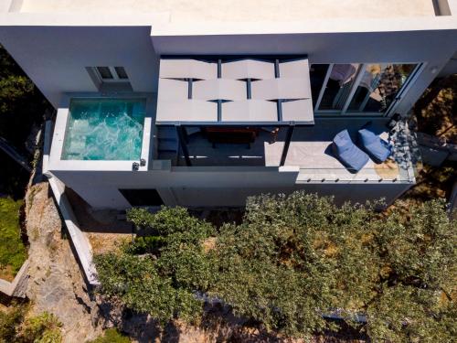 an aerial view of a house with a swimming pool at Villa Mare Syros in Finikas