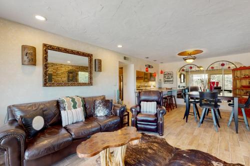 a living room with a leather couch and a table at Tranquil Trail #8 in Carefree