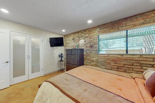 a bedroom with a brick wall and a large bed at Tranquil Trail #8 in Carefree