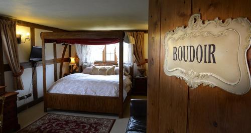a bedroom with a bed and a sign that saysumbledore at Fletchers Hall in Freckleton