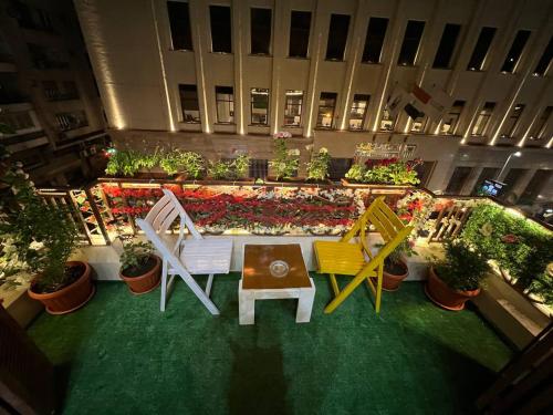 an overhead view of a patio with chairs and plants at Paris east in Cairo