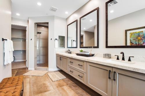 a bathroom with two sinks and two mirrors at Scottsdale Scenery in Scottsdale