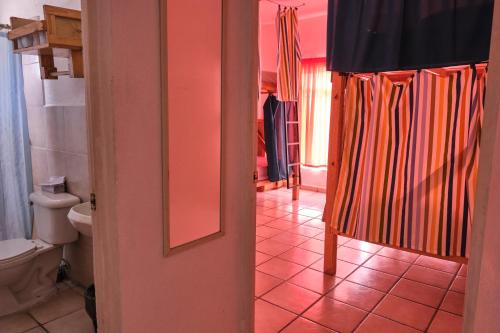a bathroom with a toilet and a shower curtain at Hostel Casa Esterito in La Paz