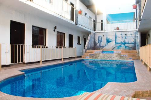 - une piscine d'eau bleue dans un bâtiment dans l'établissement Hotel Paquime, à Nuevo Casas Grandes