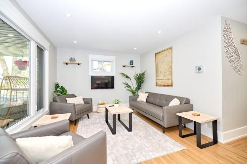 a living room with two couches and a tv at The Newark House in Niagara on the Lake