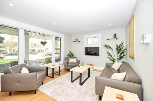 a living room with two couches and a tv at The Newark House in Niagara on the Lake