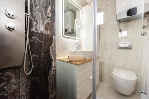 La petite salle de bains est pourvue de toilettes et d'un lavabo. dans l'établissement Holiday house with a parking space Privlaka, Zadar - 21225, à Privlaka