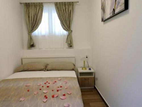 a bedroom with a bed with pink shoes on it at Apartments by the sea Preko, Ugljan - 21319 in Preko