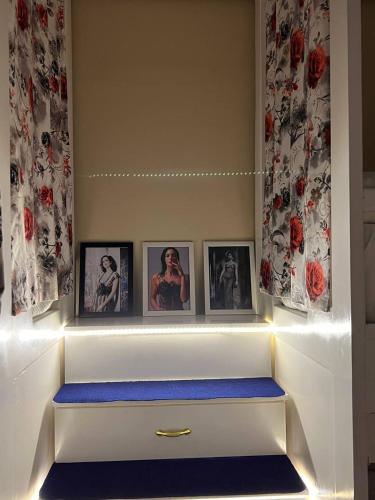 a white drawer with pictures on it with lights at Paris east in Cairo
