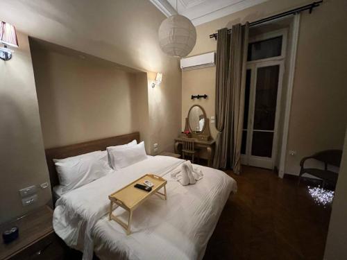 a bedroom with a bed with a table on it at Paris east in Cairo