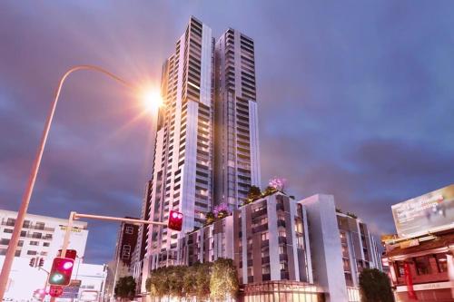 a street light with a tall building in a city at The Occidental Pearl in Sydney
