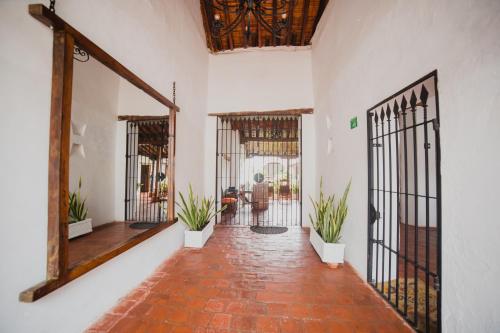 a hallway with wrought iron gates and plants at Hotel Archangelus in Mompós