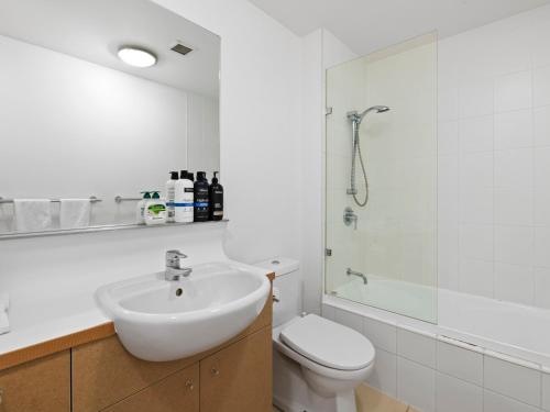 a bathroom with a sink and a toilet and a shower at Artsy Destination Compact & Cosy 2 BR Apart at Valley in Brisbane