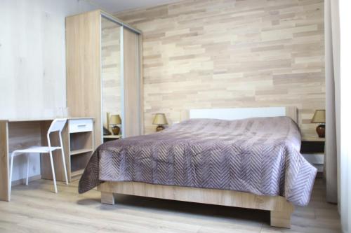 a bedroom with a bed and a desk at Кукулька міні-готель in Slavske