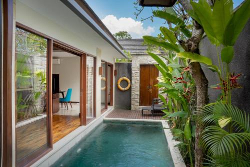 an indoor swimming pool in the backyard of a house at Sanata Luxury Villa in Canggu