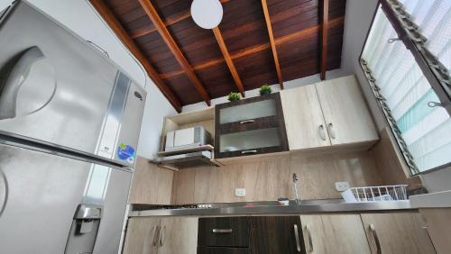 a kitchen with wooden cabinets and a large window at apartamento en ENVIGADO in Envigado