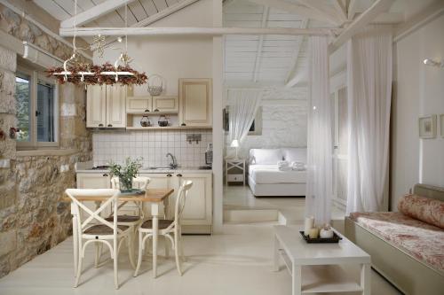 a kitchen and living room with a table and chairs at Katikies Manis in Kardamyli