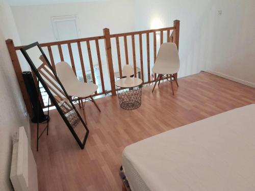 a room with two chairs and a balcony with a bed at Appartement T1 bis tout confort, proche plages et commerces, Capbreton - FR-1-239-954 in Capbreton