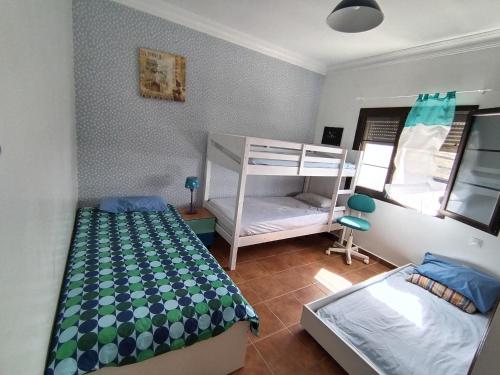 a bedroom with two beds and a bunk bed at LANZATE! in Tinajo