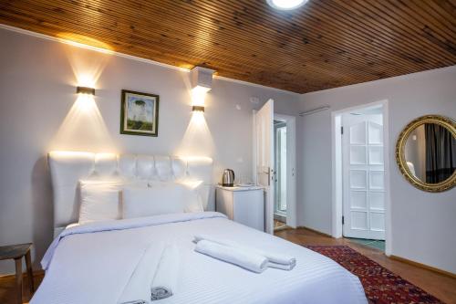 a bedroom with a white bed with lights on it at İSTANBLUE TAKSİM APART HOTEL in Istanbul