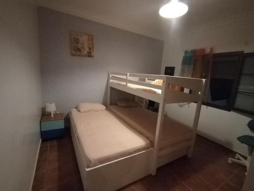 a small bedroom with a bunk bed with a ladder at LANZATE! in Tinajo
