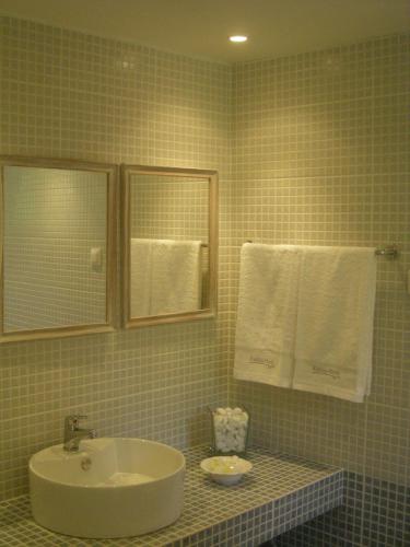 a bathroom with a sink and a mirror and towels at Katikies Manis in Kardamili